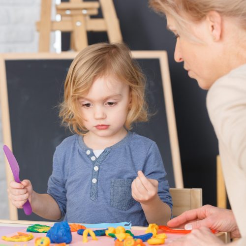 Little girl having fun at school during art classes